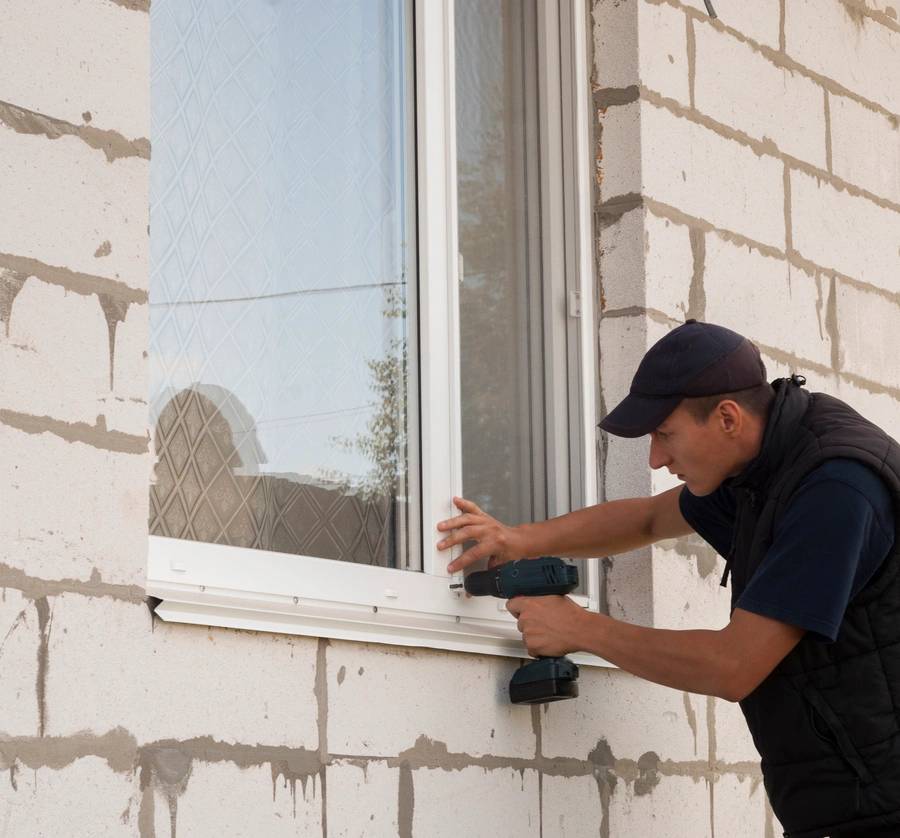 construction worker sets of metal and plastic window